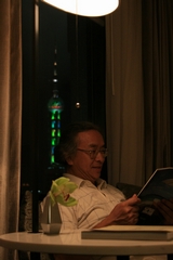 I-5-15-02-I read a magazine at the window with Orient Pearl Tower shining outside