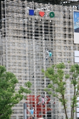 17b-Robots climbing up a grid wall in front of a Japan enterprise pavilion