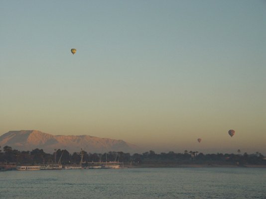 Egypt 2004---D06-01-01 Morning scene of West Luxor with several rising balloons seen from cruise ship in Nile River.jpg