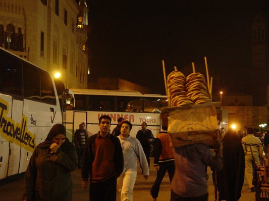Egypt 2004---D09-04-04 A man with a pile of Egyptian pizzas (fiteers).jpg