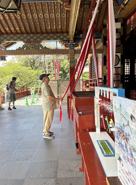 Japan 2024---02-02-05_Worshipping by pulling a rope connected to a bell in Yutoku Inari Shrine.jpg