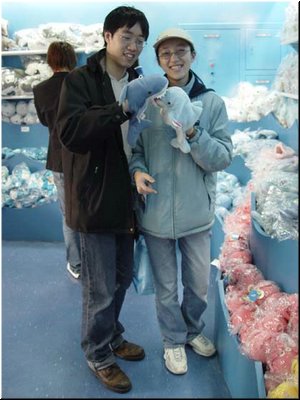03-03-01 Meimei and Hsin-Mu playing dolls in hands in a shop in the garden.jpg