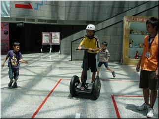 39 A boy playing a Segway scooter in the hall.jpg
