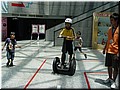 39 A boy playing a Segway scooter in the hall.jpg