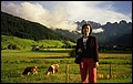 Austria 1999---08-10C 02-02 Mamma in the field with pretty scene in background.jpg