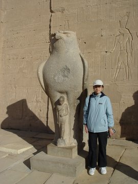 Egypt 2004---D07-03-09 Meimei at the other statue of Horus in front of the Temple (with missing top).jpg