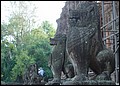 Cambodia 2006 --- Day 04-06 Preah Ko --- 02 There are a row of stone lions in front of several tower ruins.JPG
