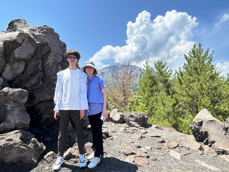 Japan 2024---04-07-02_My wife Chih-Hua's nephew and her son in front of the far-away vocano.jpg